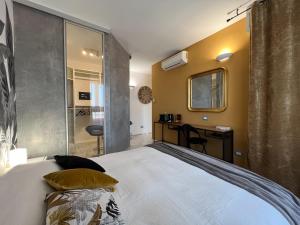 a bedroom with a bed and a desk in it at Holy-Day Rooms Milano in Milan