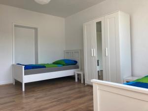 a bedroom with two beds and a mirror at gemütliche Altbauwohnung im Wuppertaler Westen in Wuppertal