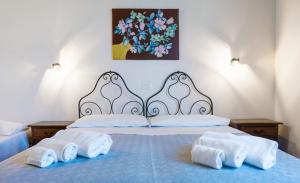 a bedroom with a bed with towels on it at Casale Ginisara in Castellammare del Golfo