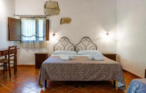 a bedroom with a bed with two towels on it at Casale Ginisara in Castellammare del Golfo