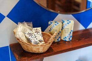 a basket of toothbrushes andodorizers on a shelf at Casale Ginisara in Castellammare del Golfo
