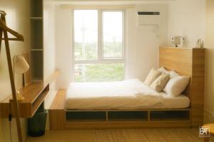 a bedroom with a bed in front of a window at Modern Japanese inspired studio at Avida Towers Atria in Iloilo City +40 photos
