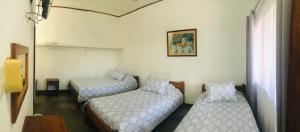 Postel nebo postele na pokoji v ubytování Hotel Del Aserradero
