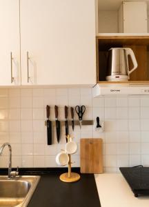 a kitchen with a counter with utensils on the wall at Modern Japanese inspired studio at Avida Towers Atria in Iloilo City