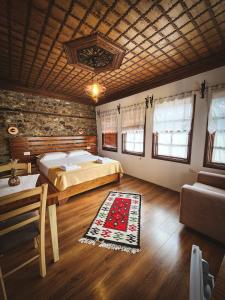 a bedroom with a bed and a table and a couch at Hotel Borklad in Berat