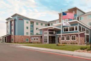 a building with an american flag in front of it at Residence Inn San Angelo in San Angelo