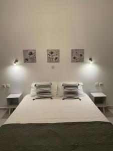 a bedroom with a large bed with two tables at IL PONTE room4 in Asklipiḯon