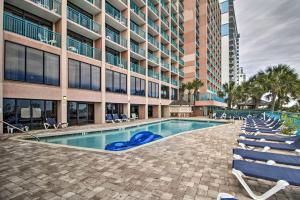 a swimming pool in front of a building at Myrtle Beach Oceanfront Condo w/ Pool & Lazy River in Myrtle Beach