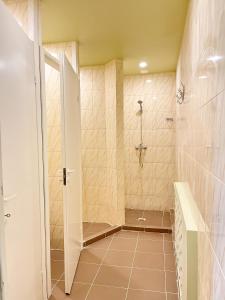a bathroom with a shower with a glass door at Hostel Kornealita in Zarasai