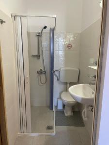 a bathroom with a shower and a toilet and a sink at IL PONTE room4 in Asklipiḯon
