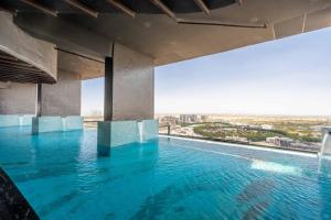 a swimming pool in a building with a view at GuestReady - Palms at heaven's door in Dubai