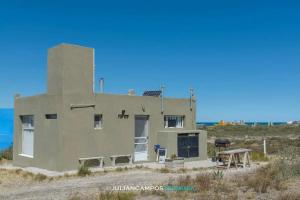 a building on the side of a beach at Casa de Mar El Qubito las Grutas in Las Grutas +15 photos
