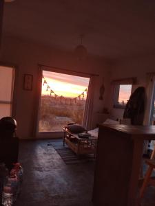 a living room with a window and a view of the desert at Casa de Mar El Qubito las Grutas in Las Grutas