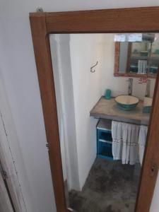 a bathroom with a sink and a mirror at Casa de Mar El Qubito las Grutas in Las Grutas