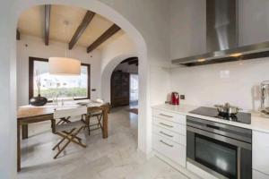 a kitchen with a table and a counter top at Villa Amor in Cala Morell