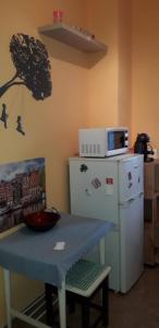 een keuken met een blauwe tafel en een koelkast bij Pamacs Apartman in Szolnok