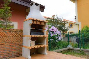 a bird house sitting on the side of a house at Chalet junto a playa de Suances in Suances +47 photos