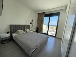 a bedroom with a bed and a view of the ocean at Luxury Villa with pool 1st line the sea in Torrevieja +26 photos