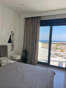 a bedroom with a bed and a view of the ocean at Luxury Villa with pool 1st line the sea in Torrevieja