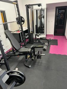 a room with a gym with a chair and weights at Krina in Sighetu Marmaţiei