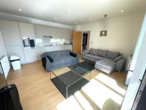 a living room with a couch and a table at Luxury London Apartment - Steps To East Croydon Train Station in Croydon