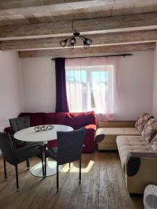 a living room with a table and a couch at Balsių namelis in Vilnius