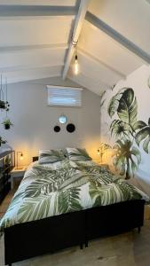 a bedroom with a bed with a plant on the wall at Royal Green in Zandvoort