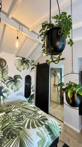 a bedroom with potted plants hanging from the ceiling at Royal Green in Zandvoort