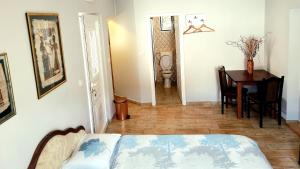 a room with a bed and a table and a dining room at Apartments Krstos place in Kotor