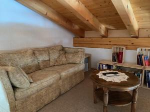 a living room with a couch and a table at Grindelwald-Sunneblick in Grindelwald
