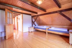 a room with two beds in a wooden room at River Valley View House in Bohinjska Bistrica