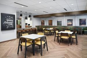a restaurant with tables and chairs and a counter at Fairfield Inn & Suites Tampa Riverview in Riverview