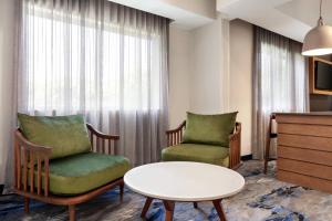 a living room with two chairs and a table at Fairfield Inn by Marriott Visalia Sequoia in Visalia