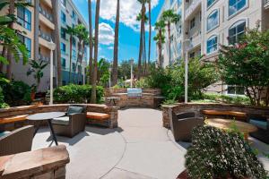 a patio with benches and tables in a building at Residence Inn Tampa Downtown in Tampa