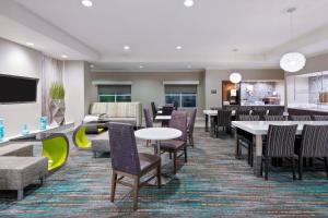 a restaurant with tables and chairs and a bar at Residence Inn Tampa Downtown in Tampa