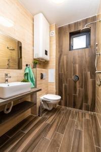 a bathroom with a sink and a toilet at Brand New Modern 1BR Apartment with Private Parking included in Plovdiv