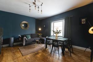 a living room with a couch and a table at Central Brighton few Steps from Brunswick Square in Brighton & Hove