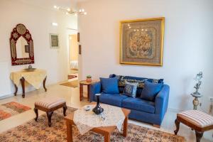ein Wohnzimmer mit einem blauen Sofa und einem Tisch in der Unterkunft My Aegean Sea Apartment in Kos-Stadt
