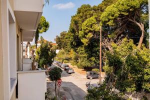 a view of a street with cars parked on the road at My Aegean Sea Apartment in Kos