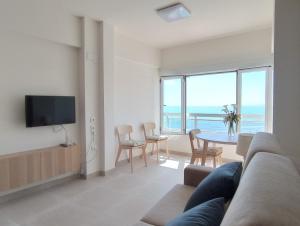 a living room with a couch and a table with chairs at Apartamento en El Prado in Cullera