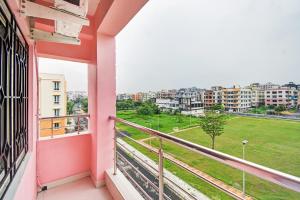 a balcony with a view of a city at Hotel O Maa Residency Near Biswa Bangla in Thākurdwari