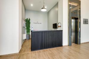 an office lobby with a black reception desk at Super Townhouse Jashn in Lucknow