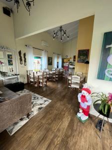 a living room with a santa claus statue in the middle of the room at Hospedaria Gengibre in Barra Velha