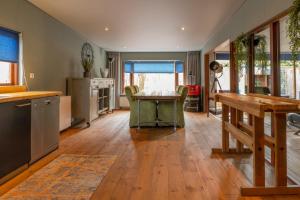 a kitchen and dining room with a wooden table at Ericaheide: Industrial look (4p) in Erm