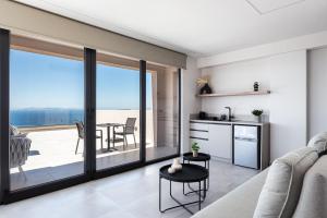 a kitchen and living room with a view of the ocean at Saronida Hills in Saronida