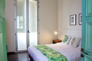 a bedroom with a bed with a green door at Hotel Casa de la Vega in Bogotá +48 photos
