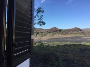 an open door of a house with a view of the desert at Natural y sano: Charco del Palo in Charco del Palo