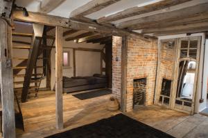 a living room with a brick wall and a fireplace at West Street Loft in Midhurst