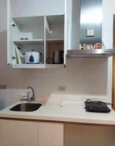 a kitchen with a sink and a counter top at Room at SM Bicutan with Balcony in Manila