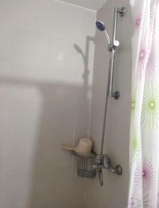 a shower in a bathroom with a shower head at Room at SM Bicutan with Balcony in Manila